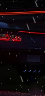 Sleek car tail lights glowing on a rainy night wallpaper.