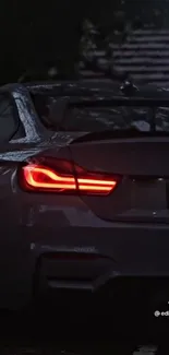 Car with glowing tail light in the rain, perfect for a dynamic mobile wallpaper.