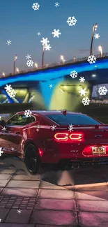 Red sports car under neon-lit bridge with snowflakes falling at night.