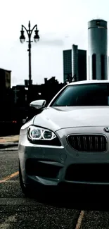 Luxury car in urban setting with city skyline.