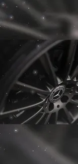 Sleek black car wheel design wallpaper for mobile.