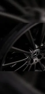 Dark gray alloy car wheel with sleek design.