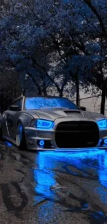 Sleek car with vibrant blue neon lights on a dark, wet street.