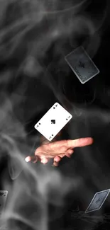 A hand skillfully flipping playing cards against a dark background.