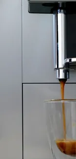 Coffee machine pours espresso into glass cup, sleek style.