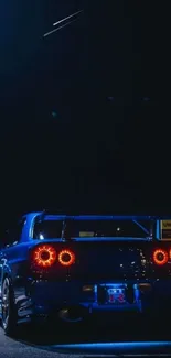 Dark blue car with glowing rear lights at night.