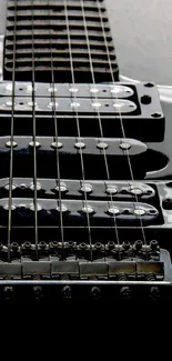 Close-up of a sleek black electric guitar with glossy finish.