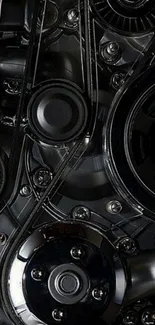 Close-up view of engine gears on mobile wallpaper in black tones.