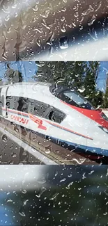 Sleek high-speed train viewed through raindrop-covered window.