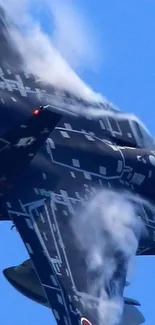 Sleek fighter jet flies through blue sky with clouds.