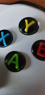 Close-up of a gaming controller with colorful buttons.