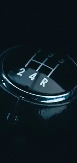 Close-up of a sleek car gear shift in dark blue lighting.