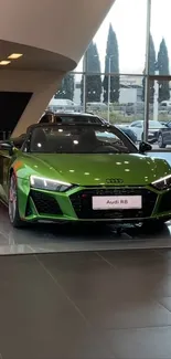 Green Audi R8 in a dealership showroom.