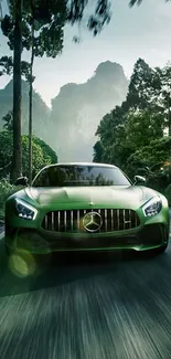 Sleek green car driving through a lush forest road.