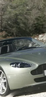 Green convertible sports car in natural setting.