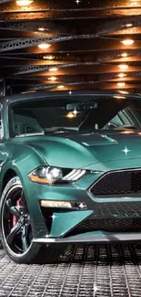 Sleek green sports car under industrial lights.