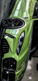 Sleek green sports car with black accents in urban setting.