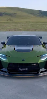 Green sports car with sleek design on open road background.