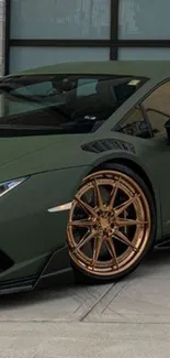 Green sports car with bronze wheels, features a matte finish.