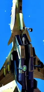 Futuristic fighter jet soaring in a vibrant blue sky with sparkling stars.