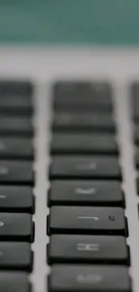 Close-up of a sleek black keyboard with a blurred background.