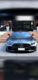 Black luxury sports car front view in urban setting.