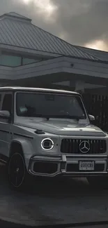 A sleek white luxury SUV parked in front of a modern house under cloudy skies.