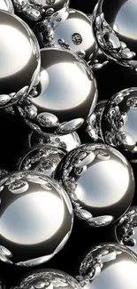 Sleek metallic orbs wallpaper with chrome spheres on a dark background.