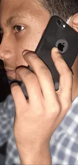 Person holding smartphone against ear.