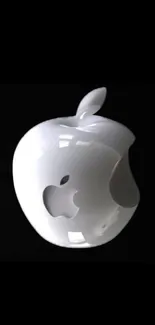 Glossy white apple sculpture on black background, minimalist design.