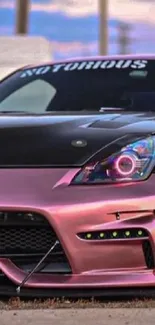 Sleek pink modified car with glossy finish.