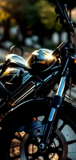 Black motorcycle standing on a street with reflective highlights.