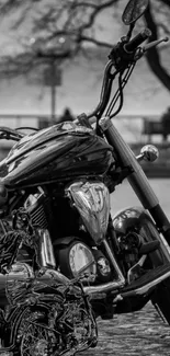 Black and white motorcycle with chrome details by a scenic backdrop.