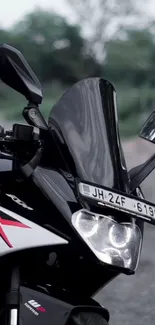 Close-up of a sleek motorcycle with a focus on the windshield and headlights.