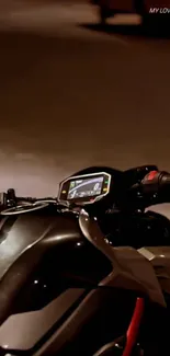 Close-up of a motorcycle dashboard at night.