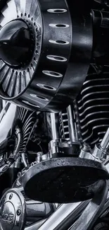 Close-up of sleek chrome motorcycle engine in black and white.