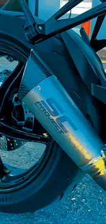 Close-up of a motorbike's rear wheel and exhaust pipe with modern design.