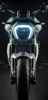 Front view of sleek motorcycle with a dark background.