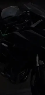 Dark motorcycle with sleek design in shadows.