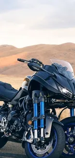 Motorcycle on a scenic desert road with mountains in the background.