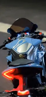 Sleek motorcycle captured during a night ride with vibrant tail lights.