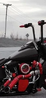 Sleek black motorcycle with red accents on an open road.