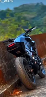 Sleek motorcycle parked on a scenic road with lush greenery.