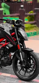 Sleek black motorcycle parked outdoors with urban backdrop.