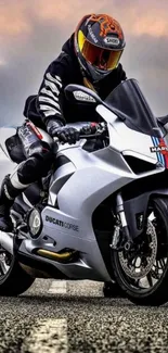 Motorcyclist on a sleek bike under dramatic skies.