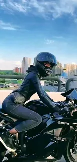 Motorcyclist rides on a glossy black bike in urban setting at sunset.