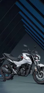 Sleek motorcycle against geometric dark blue background.