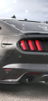 Gray Mustang car with distinctive tail lights in focus.