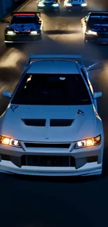 Dynamic night car chase along a dimly lit road.