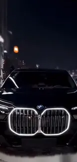 A sleek black car with illuminated lights in a modern city at night scene.